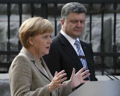 671658-germany-s-chancellor-merkel-gestures-during-a-news-conference-with-ukraine-s-president-poroshenko-in