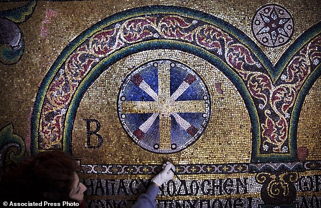 In this Feb. 4, 2016 photo, a restoration expert works on a mosaic inside the Church of the Nativity, in the West Bank city of Bethlehem. After two years of painstaking work, experts have completed the initial phase of a delicate restoration project at the Church of the Nativity, giving a much-needed face lift to one of Christianity’s holiest sites. (AP Photo/Nasser Nasser)