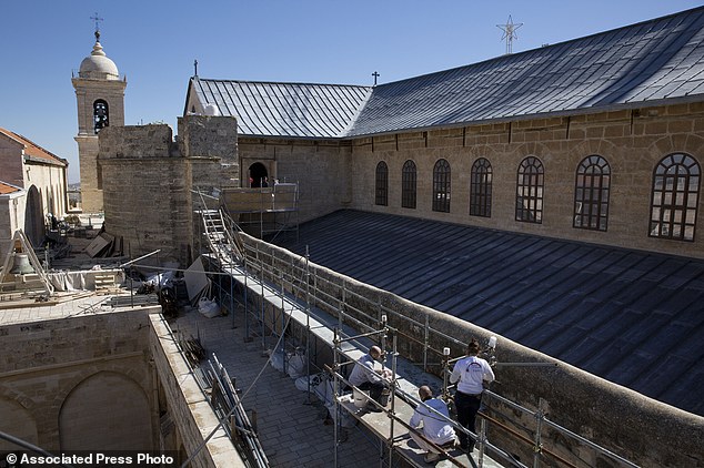 In this Feb. 4, 2016, photo, restoration experts work on the the rooftop of the Church of the Nativity, in the West Bank city of Bethlehem. After two years of painstaking work, experts have completed the initial phase of a delicate restoration project at the Church of the Nativity, giving a much-needed face lift to one of Christianity’s holiest sites. The project, partially funded by the Palestinians and conducted by a team of Palestinian and international experts, is the biggest restoration at the iconic church in some 600 years. (AP Photo/Nasser Nasser)