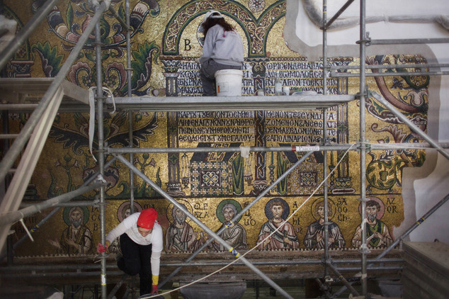 In this Feb. 4, 2016 photo, restoration experts work on mosaic inside the Church of the Nativity, in the West Bank city of Bethlehem. After two years of painstaking work, experts have completed the initial phase of a delicate restoration project at the Church of the Nativity, giving a much-needed face lift to one of Christianity’s holiest sites. For the first time in almost 1,000 years the thousands of fine mosaics' tiles have been retouched. (AP Photo/Nasser Nasser)