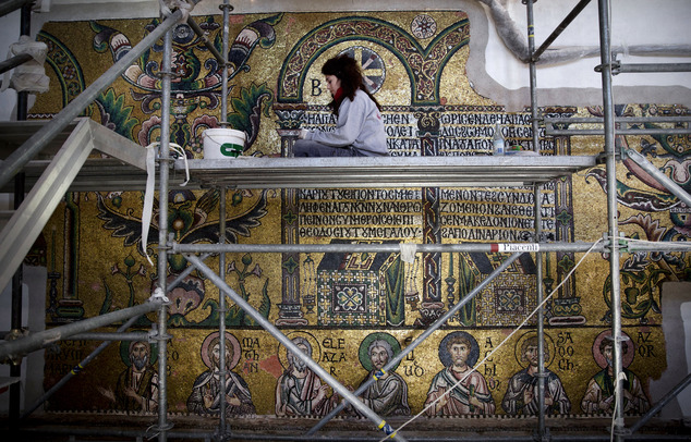 In this Feb. 4, 2016 photo, a restoration expert works on mosaic inside the Church of the Nativity, in the West Bank city of Bethlehem. After two years of painstaking work, experts have completed the initial phase of a delicate restoration project at the Church of the Nativity, giving a much-needed face lift to one of Christianitys holiest sites. (AP Photo/Nasser Nasser)